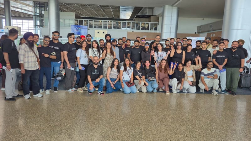 Large group of the India team in Maropost T-shirts at an airport