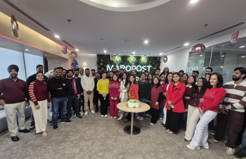 India team Christmas group photo in front of the Maropost sign