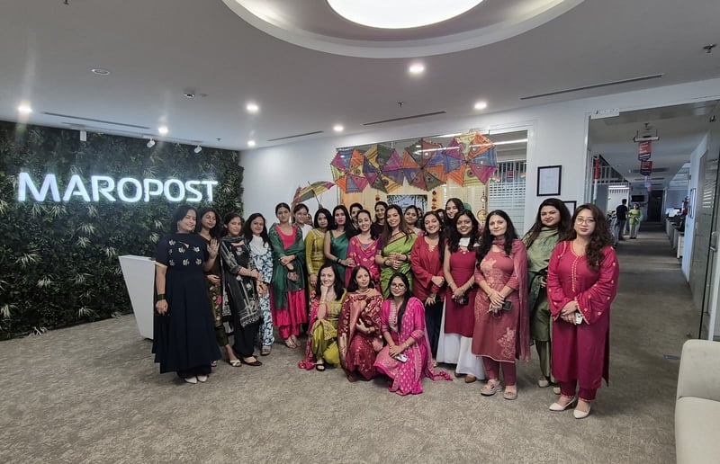 India team members in traditional dress for a festival in front of the Maropost sign