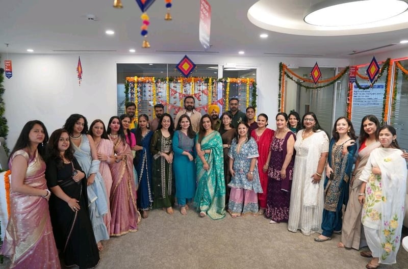 India team in traditional dress at a festival celebration in the office