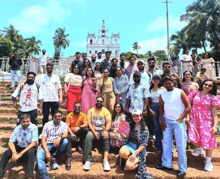 India team trip group photo in front of a white church in Goa