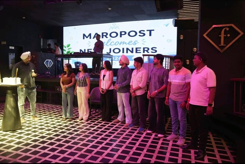 New joiners on stage under a Maropost welcomes new joiners screen