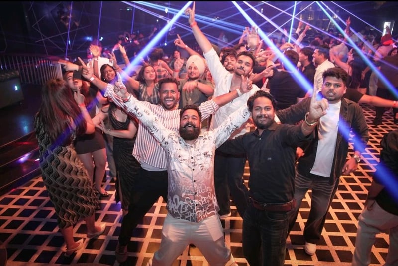 Team dancing under stage lights at a party