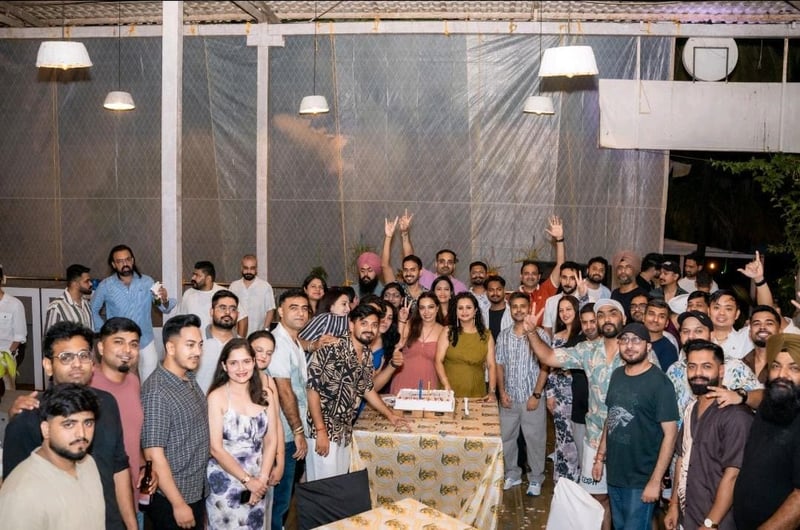 Large India team group photo celebrating at a party venue