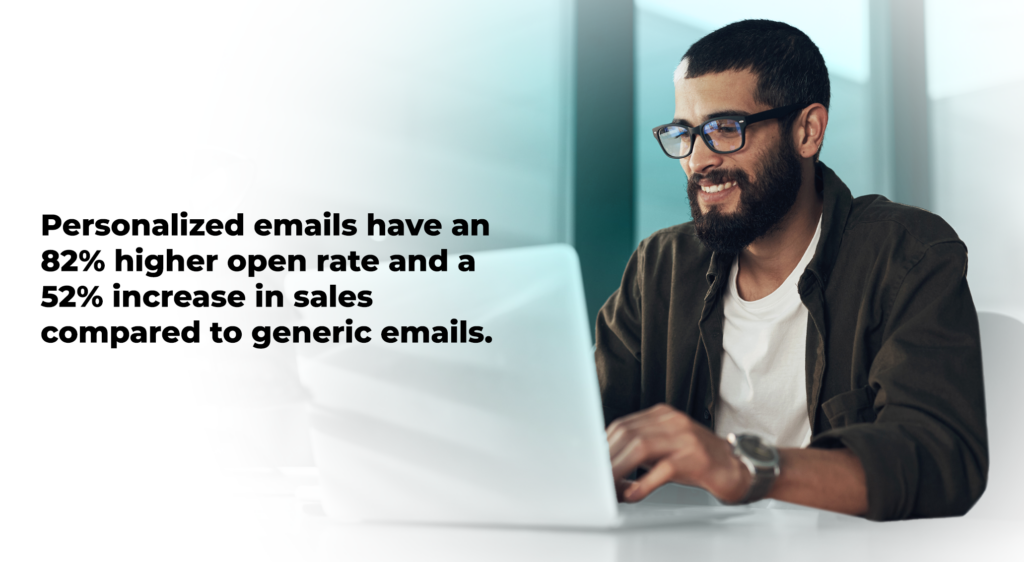 A smiling man with a beard and glasses works on a laptop. To the left of the image, text reads: "Personalized emails have an 82% higher open rate and a 52% increase in sales compared to generic emails." The background is a modern, softly-lit office setting.